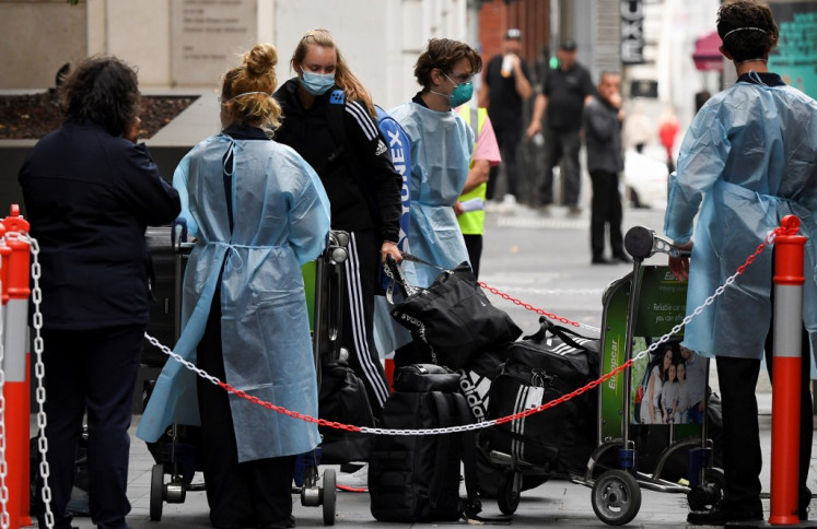 Tennis players, coaches and officials arrive at a hotel in Melbourne on January 15, 2021, before quarantining for two weeks ahead of the Australian Open tennis tournament. 