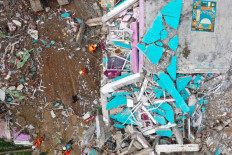 A rescue team searches the collapsed Mitra Manakarra hospital on Jan. 18, after a 6.2 magnitude earthquake shook Mamuju, West Sulawesi, on Jan. 15.