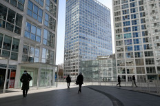 Pedestrians walk in the central business district (CBD) of Beijing on January 18, 2021. 
