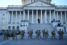 Members of the US National Guard walk outside the US Capitol on January 19, 2021 in Washington, DC, ahead of the 59th inaugural ceremony for President-elect Joe Biden and Vice President-elect Kamala Harris. 