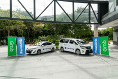 GrabCar Premium vehicles bearing the logo of Panasonic’s proprietary nanoe™ X technology are on display in this handout photo from Grab. In response to the COVID-19 pandemic, Grab and Panasonic have joined hands to ensure air hygiene for customers through the premium ride-hailing service, which was launched in five major cities in four Southeast Asian countries, including Jakarta. 