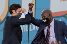 In this file photo taken on Jan.4, Democratic candidates for Senate Jon Ossoff (left) and Raphael Warnock (right) bump elbows on stage during a rally with US President-elect Joe Biden outside Center Parc Stadium in Atlanta, Georgia. Two Georgia Democrats were sworn in on Wednesday as the newest members of the US Senate, handing their party control of the upper chamber just hours after President Joe Biden took office.
