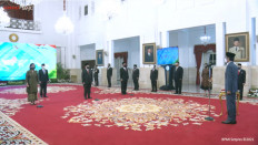 President Joko "Jokowi" Widodo (right) swears in supervisory board members of sovereign wealth fund the Indonesia Investment Authority (INA) at the State Palace in Jakarta on Jan. 27, 2021 in this screen grab from the Presidential Secretariat's official YouTube account.