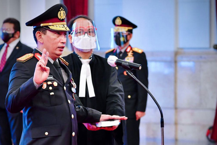 Gen. Listyo Sigit Prabowo (left) takes the oath of office during his inauguration as the new National Police chief at the State Palace on Jan. 27, 2021.