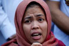 Siti Aisyah, who was previously a suspect in the murder case of North Korean leader's half brother Kim Jong Nam reacts as she talks during news conference at Halim Perdanakusuma airport in Jakarta on March 11, 2019. 