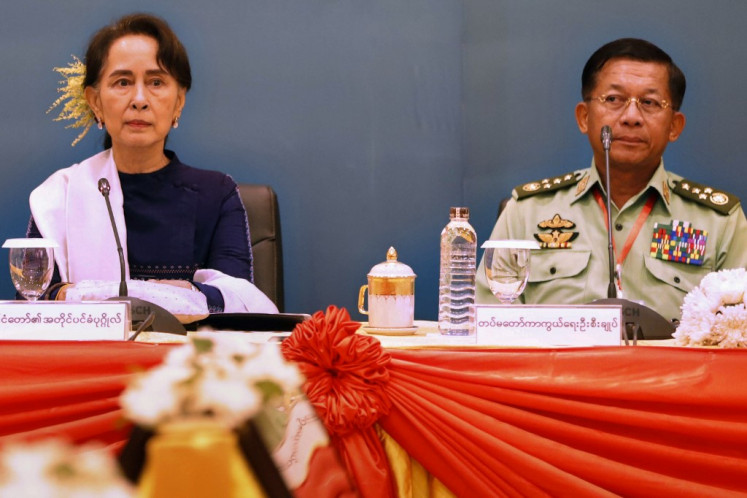  In this file handout picture released by Myanmar State Counselor Office and taken on October 15, 2018, Myanmar's State Counsellor Aung San Suu Kyi (L) and military chief Senior General Min Aung Hlaing attend a meeting in Naypyidaw. Myanmar's military seized power in a bloodless coup on February 1, 2021, detaining democratically elected leader Aung San Suu Kyi as it imposed a one-year state of emergency. 
