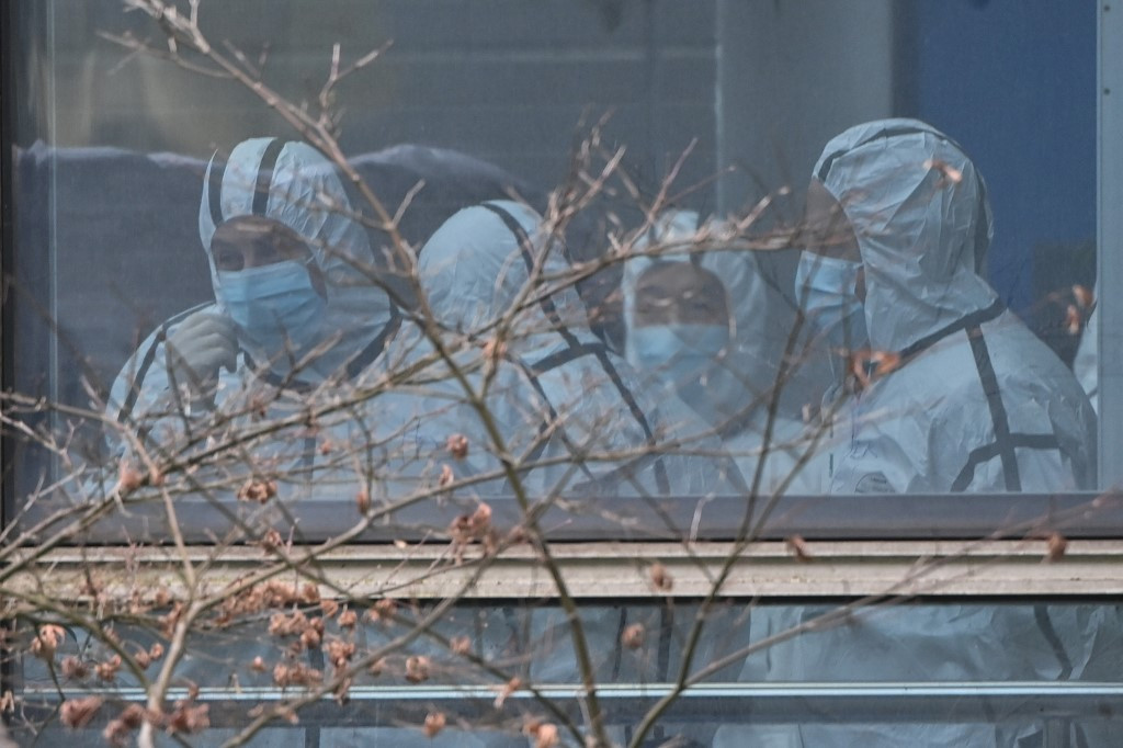 Members of the World Health Organization (WHO) team investigating the origins of the Covid-19 coronavirus, wearing protective gear are seen during their visit to the Hubei Center for animal disease control and prevention in Wuhan, China's central Hubei province on February 2, 2021.