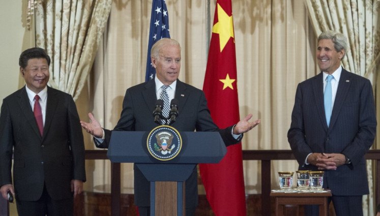 Chinese President Xi Jinping (left) and US Secretary of State John Kerry (right) listens as then US Vice President Joe Biden speaks during a State Luncheon for China hosted by Kerry on September 25, 2015 at the Department of State in Washington, DC.