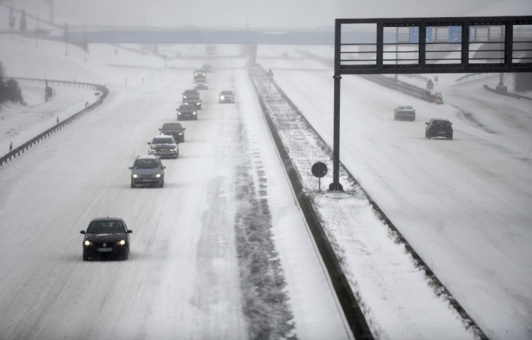 Cars make their way on the snowy motorway A2 near Kamen, western Germany on February 7, 2021. 
