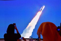This file photo taken on July 20, 2020, shows a screen broadcasting the launch of the 