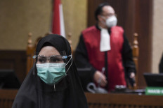 Suspended prosecutor Pinangki Sirna Malasari stands during the verdict hearing at the Jakarta Corruption Court on Feb. 8, 2021. Judges sentenced her to 10 years in prison for accepting bribes from Djoko Tjandra in exchange for securing a Supreme Court acquittal.