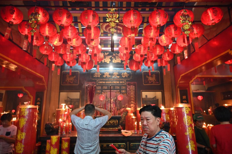 Chinese-Indonesians make offerings at a temple in Jakarta on February 19, 2019 to mark the Cap Go Meh Festival. 