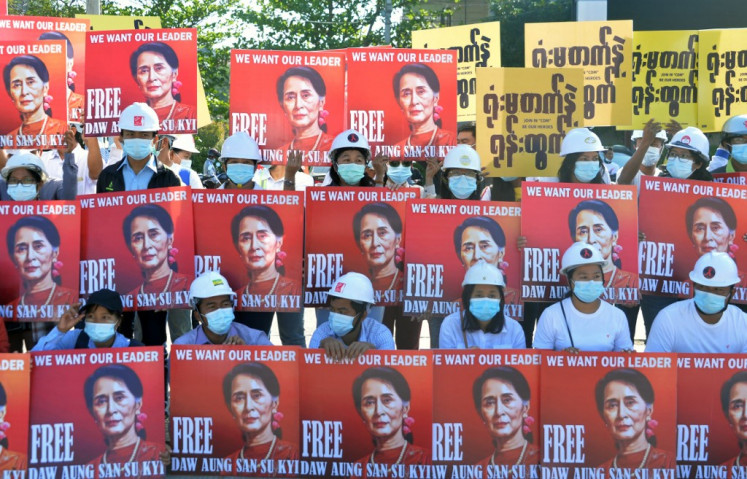 A group of protesting engineers hold up signs calling for the release of detained Myanmar civilian leader Aung San Suu Kyi during a demonstration against the military coup in Naypyidaw on Monday. 