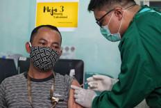Medical worker receives Covid 19 vaccine at Puskesmas Jurang Mangu, South Tangerang, Banten, Friday, January 15, 2021. Medical Workers and Helath Center Workers receive first priority for covid 19 vaccination after President Joko Widodo alias Jokowi became the first recipient of this Sinovac vaccine on January 13, 2021. 