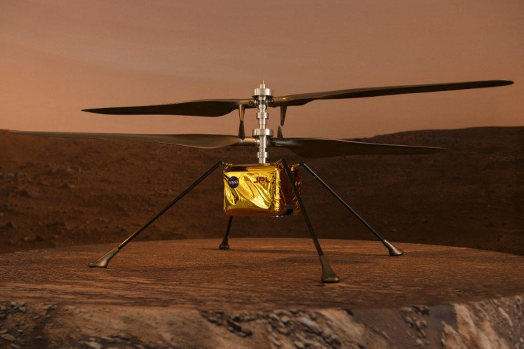 A full scale model of the experimental Ingenuity Mars Helicopter, which will be carried under the Mars 2020 Perseverance rover, is displayed at NASA's Jet Propulsion Laboratory (JPL) on February 16, 2021 in Pasadena, California. The Mars exploration rover will search for signs of ancient microbial life and collect rock samples for future return to Earth to study the red planet's geology and climate, paving the way for human exploration. Perseverance also carries the experimental Ingenuity Mars Helicopter - which will attempt the first powered, controlled flight on another planet.