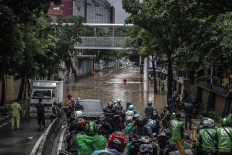 Motorists stop their vehicle at the edge of the flooded Jl. Warung Buncit Raya in South Jakarta on Feb. 20, 2021.