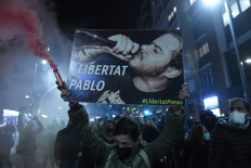 Protesters march with a picture of Spanish rapper Pablo Hasel reading 