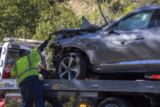 A sign for the Genesis Invitational golf tournament is seen on the door of the car that golf legend Tiger Woods was driving when seriously injured in a rollover accident on February 23, 2021 in Rolling Hills Estates, California. 