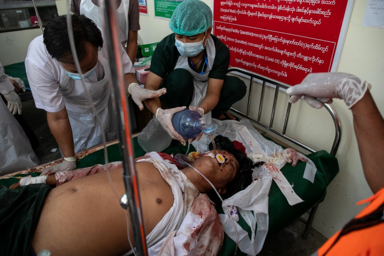A man, injured after being shot at with live rounds, is transported to a makeshift medical centre in Mandalay on February 28, 2021, as security forces continue to crackdown on demonstrations by protesters against the military coup.  (Agence France Presse/STR).
Usage: 0