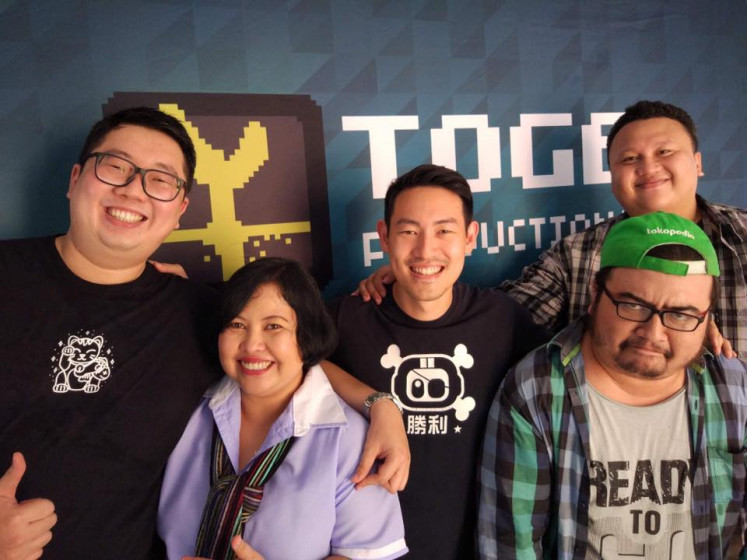 Toge Productions CEO Kris Anthony with members of his team