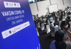 Journalists wait to receive their first vaccine dose on Feb. 25, 2021 at a COVID-19 vaccination drive in Senayan, Jakarta. Indonesia is proceeding with phase two of its vaccine rollout, even as it waits to receive additional supplies through the COVAX Facility.