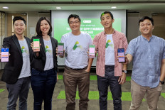 A handout photo from Advotics dated March 12, 2020 shows the software company's (from left) cofounder and CEO Boris Sanjaya, head of growth Venny Septiani, cofounder and CTO Hendi Chandi, and cofounder and CPO Jeffry Tani, as well as Danone online channel & business development manager Ardhi Hiang Sawak (right). (Courtesy of Advotics)