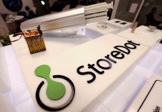 A display promoting fast-charging batteries at the entrance of the Israeli startup StoreDot's headquarters is pictured in the Israeli coastal city of Herziliya on February 16, 2021. 