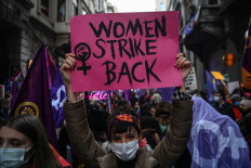 Women hold placards during a rally marking International Women's Day near Istiklal avenue in Istanbul on March 8.