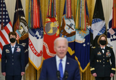 US President Joe Biden (C) speaks, flanked by the nominees to positions as 4-star Combatant Commanders General Jacqueline Van Ovost (L) and Lieutenant General Laura Richardson (R), during International Women's Day in the East Room of the White House in Washington, DC on March 8.