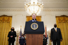US President Joe Biden (center) speaks, flanked by the nominees to positions as 4-star Combatant Commanders General Jacqueline Van Ovost (2nd left) and Lieutenant General Laura Richardson (2nd right), Vice President Kamala Harris (left) and Defense Secretary Lloyd Austin, during International Women's Day in the East Room of the White House in Washington, DC on March 8, 2021. 