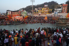 Hindu devotees take a holy dip in the waters of the River Ganges on the Shahi snan (grand bath) on the occasion of Maha Shivratri festival during the ongoing religious Kumbh Mela festival in Haridwar on March 11, 2021. 