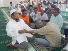 Ustadz Ahmad Junaidi (left) provides group 'ruqyah' therapy at a mosque in Manggar, East Belitung, Bangka Belitung Islands province. 'Ruqyah' is a form of faith healing in Indonesia, often referred to as "Islamic exorcism".
