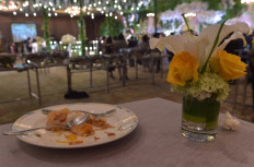 A plate with food leftovers is seen at a wedding at a hotel in Jakarta on March 19, 2018. In the slums of Jakarta, Indonesia's poor are getting a taste of how the other half live, thanks to a new program that aims to take a bite out of its mammoth food-waste problem.