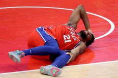 Joel Embiid of the Philadelphia 76ers reacts after getting injured in the second half against the Washington Wizards at Capital One Arena on March 12.