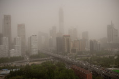 Parts of the central business district are shrouded in a dust storm in Beijing on May 4, 2017. A major dust storm engulfed northern China and Beijing on May 4, prompting authorities to cancel dozens of flights and urge children and the elderly to stay indoors.
