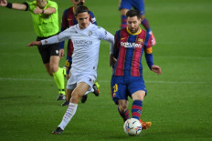 Barcelona's Argentinian forward Lionel Messi challenges Huesca's Spanish midfielder Jaime Seoane during the Spanish League football match between Barcelona and SD Huesca at the Camp Nou stadium in Barcelona on March 15.