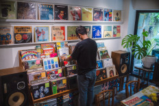 A visitor browses through SUBO's vinyl collection, which is made up of a lot of vintage music.