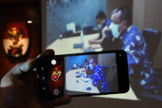 Former Supreme Court secretary Nurhadi (right) attends a virtual verdict hearing at the Corruption Eradication Commission (KPK) headquarters in Jakarta on March 10, 2021. Judges found the defendant guilty in a bribery case pertaining to three cases in the Supreme Court between 2011 and 2016 and sentenced him to six years' imprisonment and a Rp 500 million (US$34,662) fine.