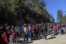 People attend the funeral of Rubelsy Tomas Isidro, a Guatemalan migrant murdered alongside 18 other people in the northern Mexican state of Tamaulipas last month, during his funeral in the village of Durasnal in Comitancillo, Guatemala, on March 13, 2021. 