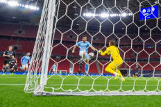 Manchester City's German midfielder Ilkay Gundogan (2nd R) kicks the ball as Borussia Moenchengladbach's Swiss goalkeeper Yann Sommer (R) reaches to block it during the UEFA Champions League, last 16, second-leg football match between Manchester City and Borussia Monchengladbach at the Puskas Arena in Budapest on March 16. Manchester City won the match 2-0.