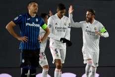 Real Madrid's Spanish defender Sergio Ramos (R) celebrates his goal during the UEFA Champions League round of 16 second leg football match between Real Madrid CF and Atalanta at the Alfredo di Stefano stadium in Valdebebas, on the outskirts of Madrid on March 15.