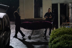 People with the medical examiner's office wheel out a body on a stretcher from a massage parlor where three people were shot and killed on March 16, 2021, in Atlanta, Georgia. Eight people were killed in shootings at three different spas in the US state of Georgia on March 16, police and local media reported. It is 