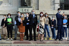 In this file photo taken on June 10, 2020 members of The 