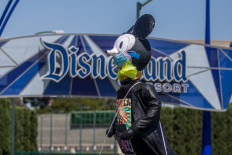 In this file photo taken on June 27, 2020 a makeshit Mickey Mouse on top of a car circles around Disneyland Resort calling for higher safety standards before its reopening, amid the coronavirus pandemic in Anaheim, California. 