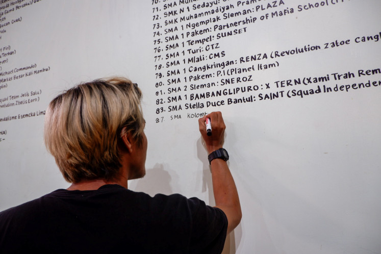 A visitor writes down the name of his high school gang