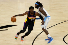 Deandre Ayton #22 of the Phoenix Suns handles the ball against Montrezl Harrell #15 of the Los Angeles Lakers during the second half of the NBA game at Phoenix Suns Arena on March 21 in Phoenix, Arizona. The Suns defeated the Lakers 111-94. 
