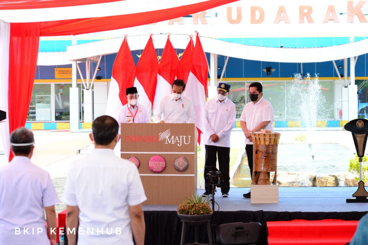 President Joko Widodo (left), Transporation Minister Budi Karya Sumadi (second right) and State-Owned Enterprises Minister Erick Thohir (right) inaugurate the Kuabang Airport extension in North Halmahera, North Maluku on March 24.