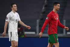 Azerbaijan's defender Anton Krivotyuk (L) and Portugal's forward Cristiano Ronaldo leave the pitch at the end of the FIFA World Cup Qatar 2022 qualification football match between Portugal and Azerbaijan on March 24 at the Juventus Stadium.