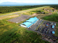 Kuabang Airport's new terminal with its bright blue roof in North Halmahera, North Maluku, at an unspecified date. The new terminal is built beside the red-roofed, smaller, old terminal seen in the background of the picture.
