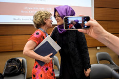 United Nations special rapporteur on extrajudicial, summary or arbitrary executions Agnes Callamard (left), who issued a report of the killing of Saudi journalist Jamal Khashoggi, greets Khashoggi's fiancee and Turkish writer Hatice Cengiz at a side event as someone takes a picture with a mobile phone during the United Nations Human Rights Council in Geneva on June 25, 2019. 